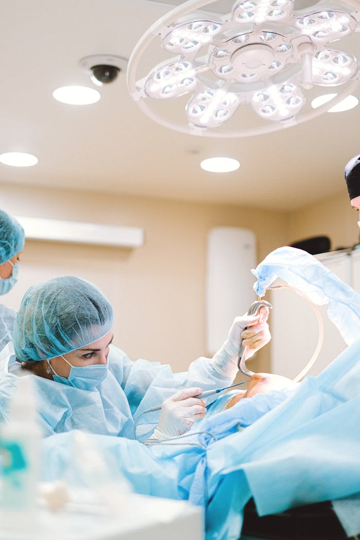 Team of surgeons working in a sterile operating room environment with focus and precision.
